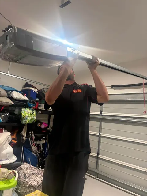 Peter Garage Doors technician installing a garage door opener motor in a Brisbane home garage